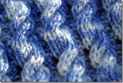 close up of reversible cable baby blanket for hand or machine knitting