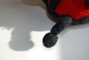 felted knitting ladybug antennae closeup in black wool yarn